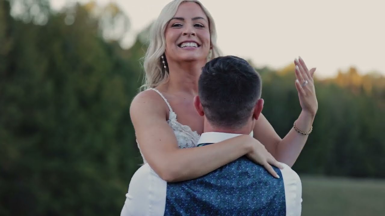 Nick and Tara embracing at golden hour, a still from their wedding film at Meadows at Mossy Creek